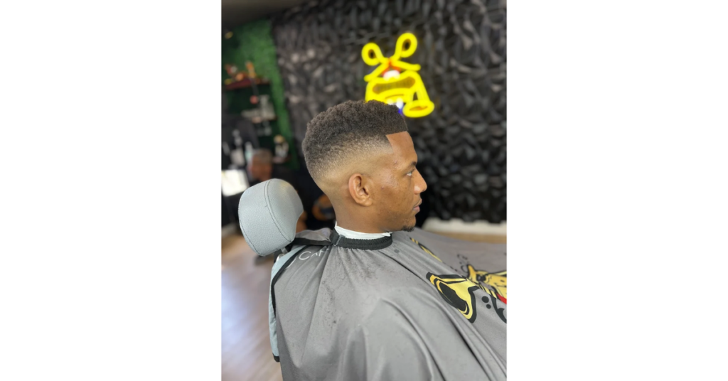 Professional barber providing a men's haircut at the best barber shop in Antioch CA
