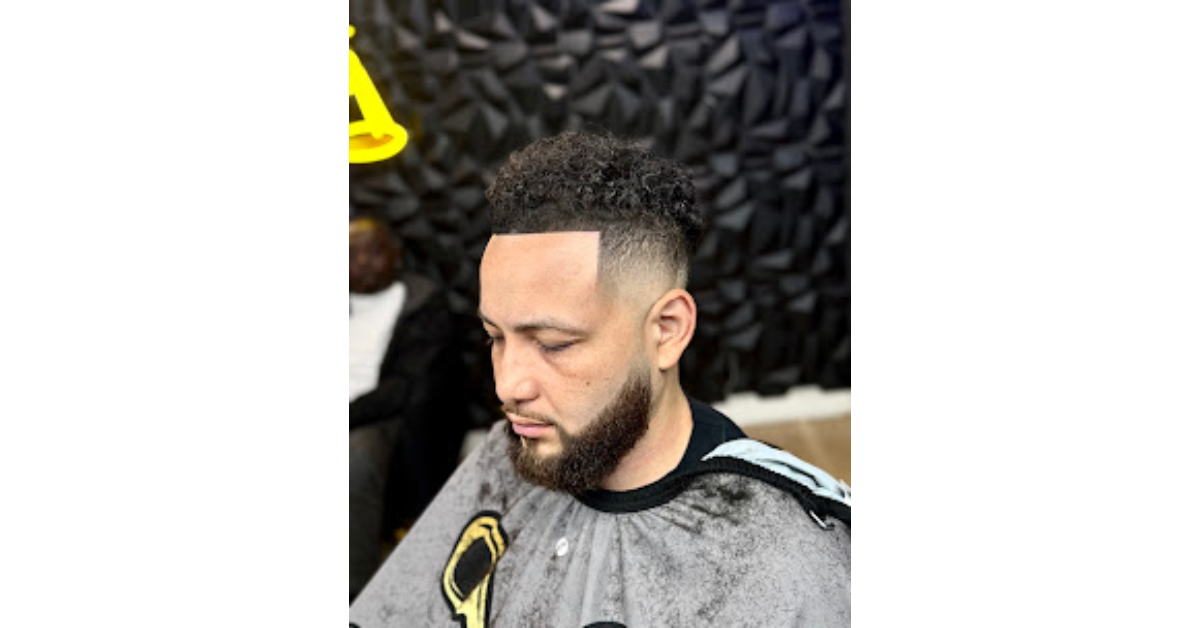 Professional barber giving a fresh haircut while explaining how often should men get a haircut for proper grooming